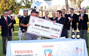 A check is presented to Duffy Waldorf